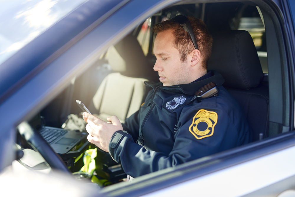 Police, phone and patrol with man in car for crime investigation unit, forensic and law enforcement. Justice, security guard and detective with person for safety officer, emergency and surveillance.