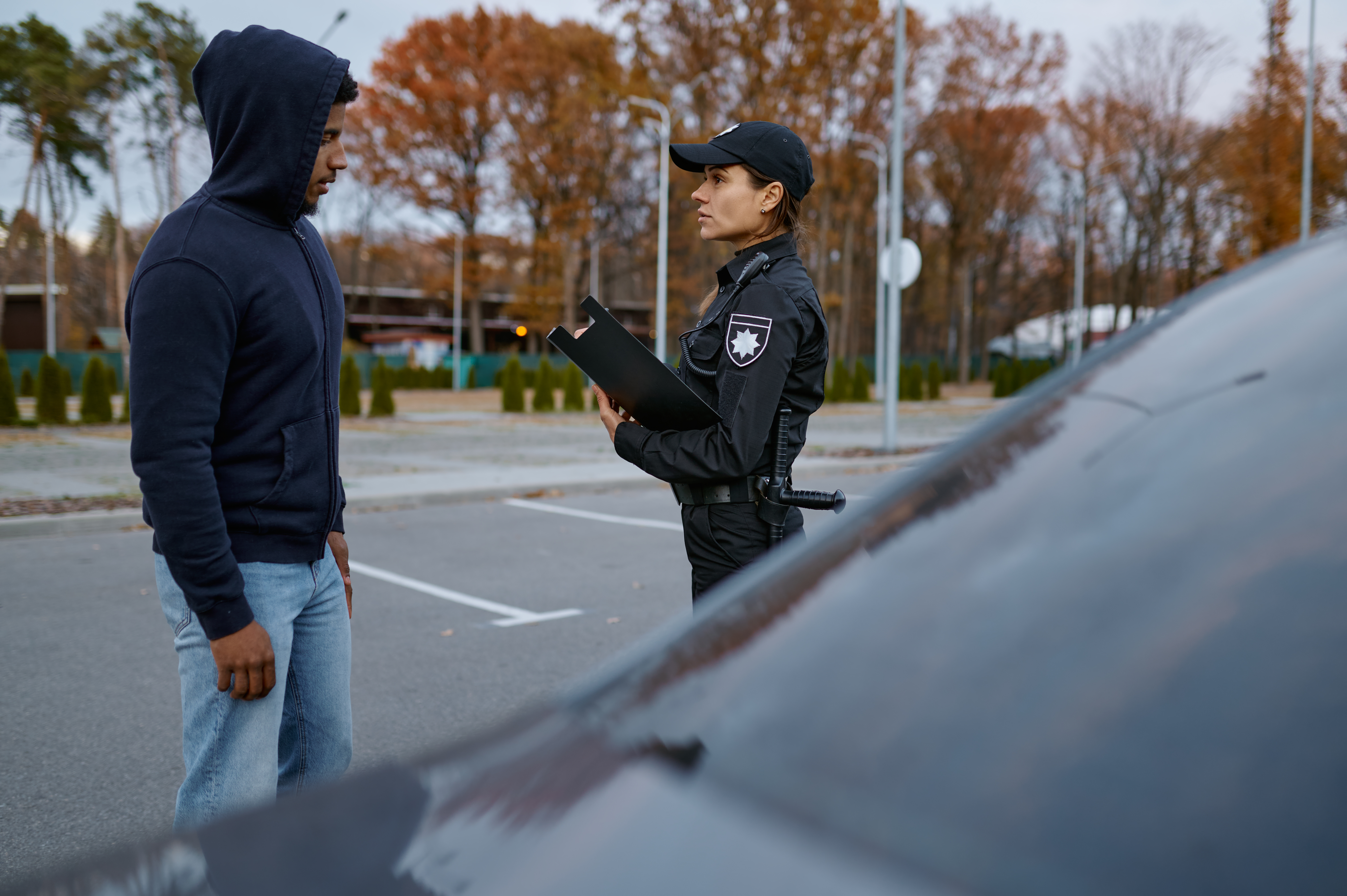 Police woman officer issuing fine ticket to offender. Female cop doing her job. Offense punishment